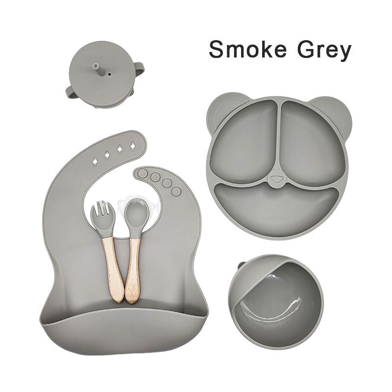 Silicone dinner plate set includes bib, spoon, and cup.