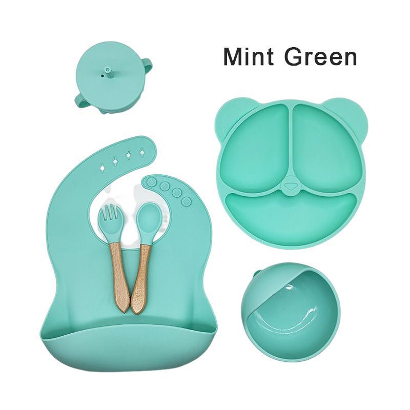 Silicone dinner plate set includes bib, spoon, and cup.